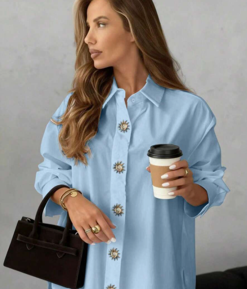 Women's white winter loose-fitting shirt with front buttons, decorative metal sun disk, dropped shoulders and lapel collar, Solstice Apparel