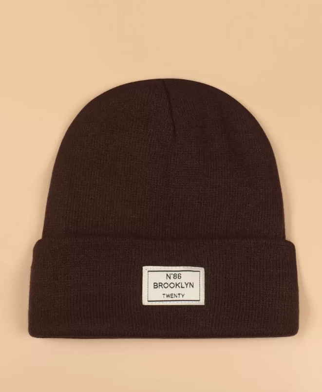 A small hat decorated with a phrase patch
